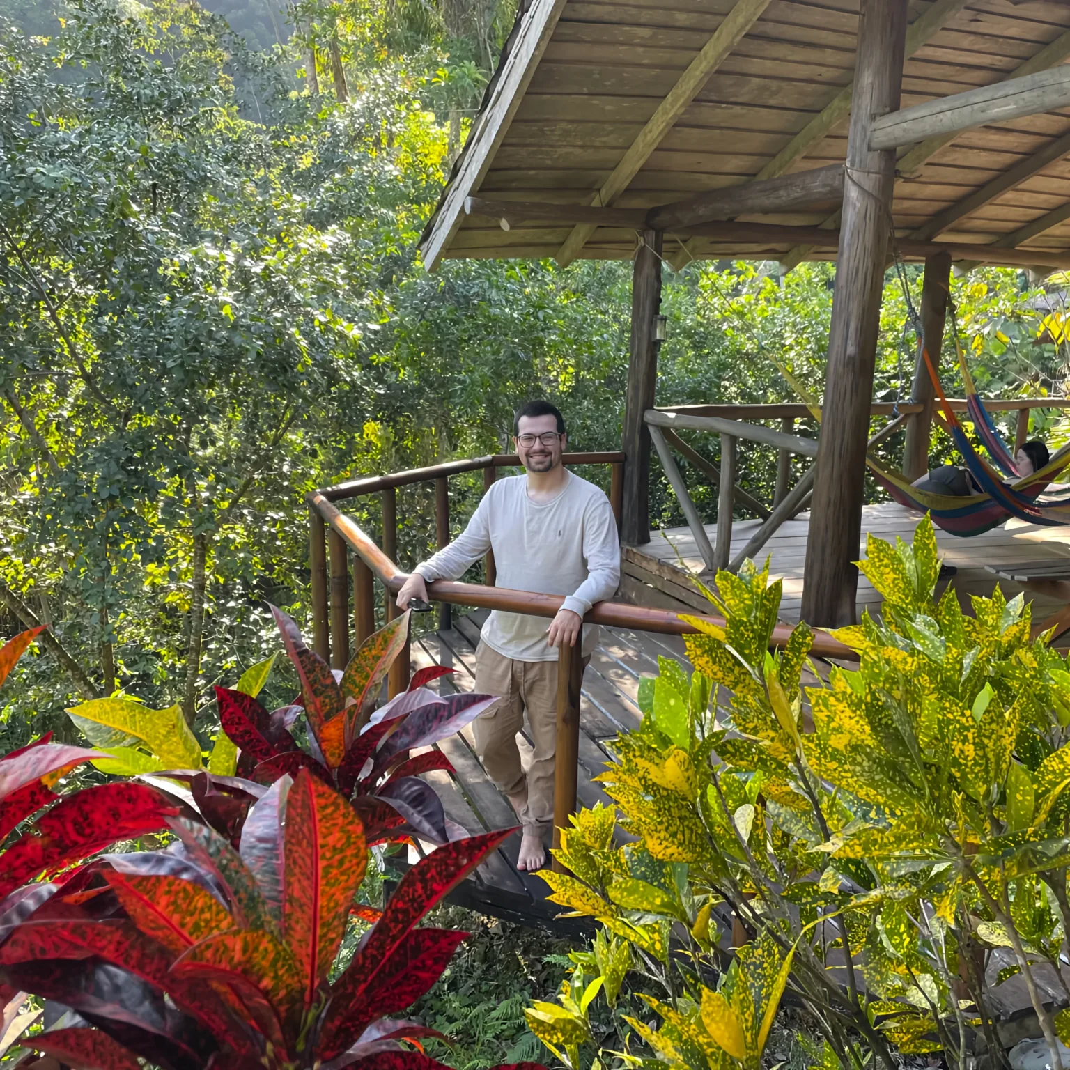 Pacuare River Ecolodge guest on wooden deck surrounded by lush greenery