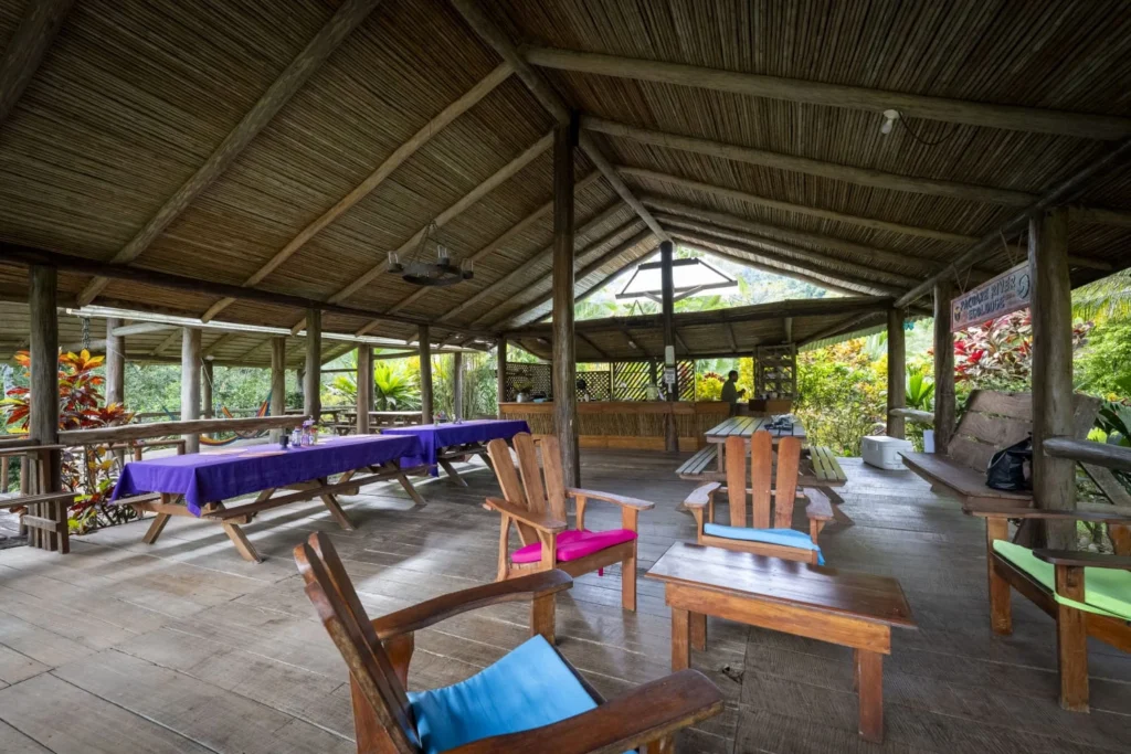 Pacuare River Ecolodge rustic dining area with wooden chairs and tables