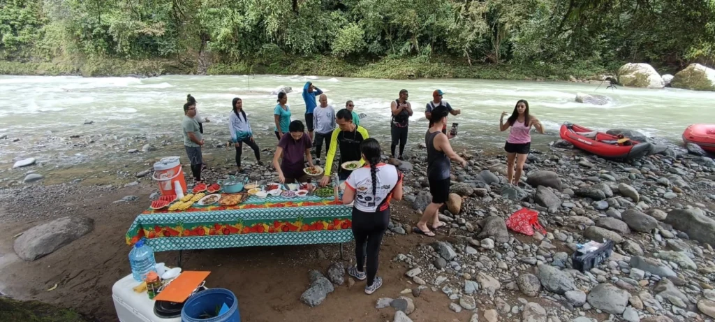 Pacuare River Ecolodge guests enjoying riverside picnic with kayaks