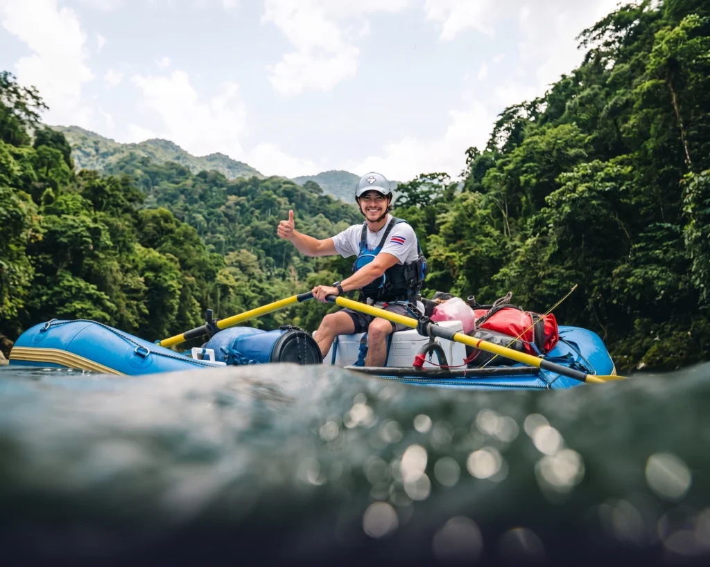 Pacuare River rafting guide thumbs up lush forest background
