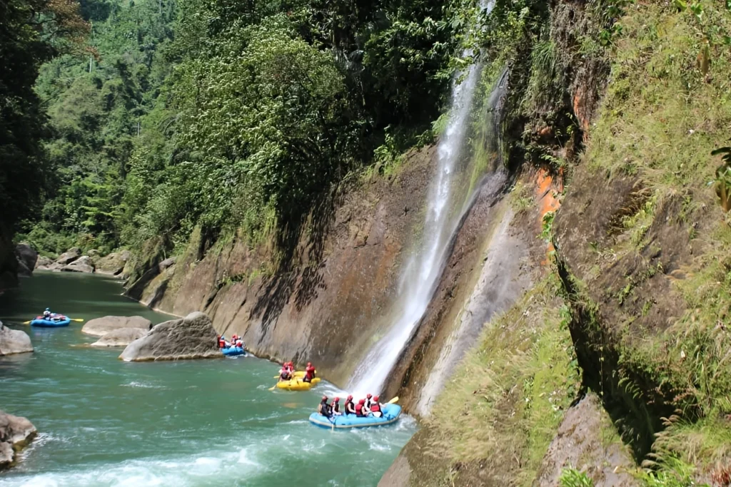 Pacuare River rafting adventure with waterfall and lush greenery