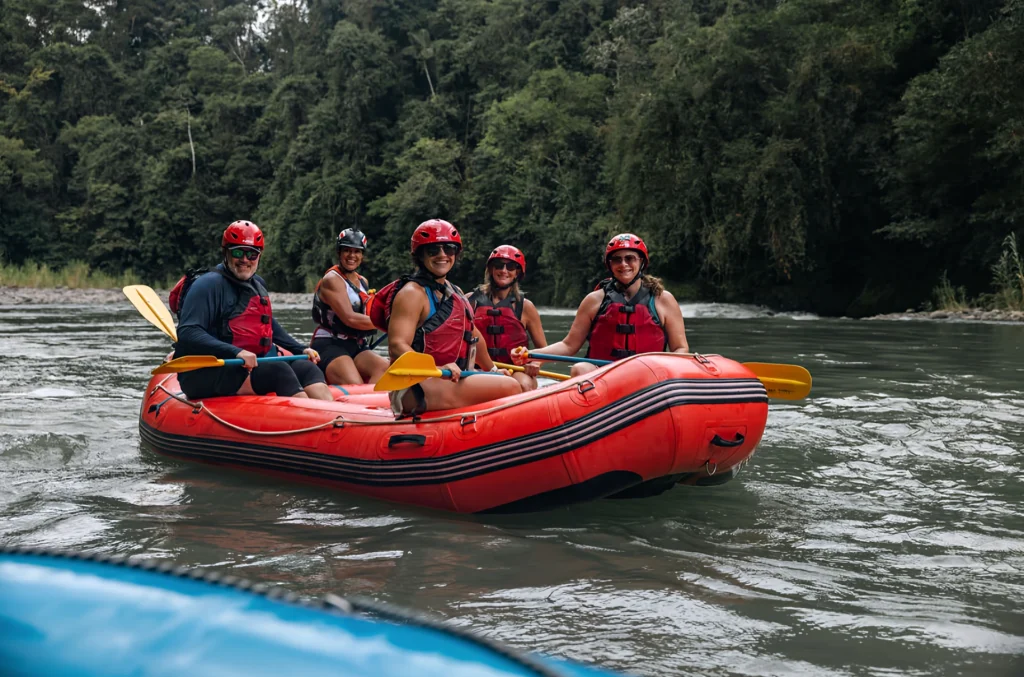 Pacuare River rafting group in red raft, lush forest background