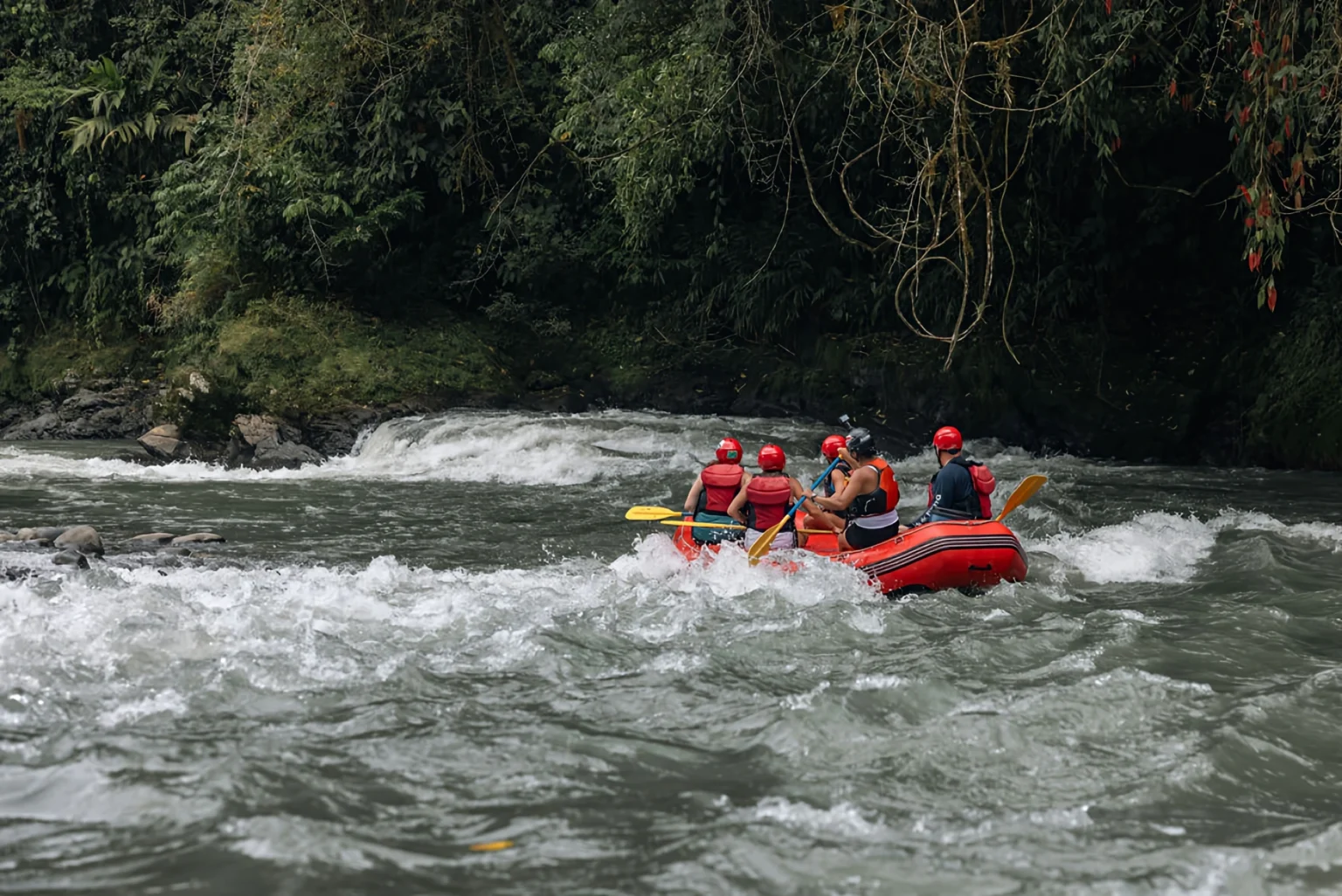 Pacuare River rafting adventure with group in red raft.