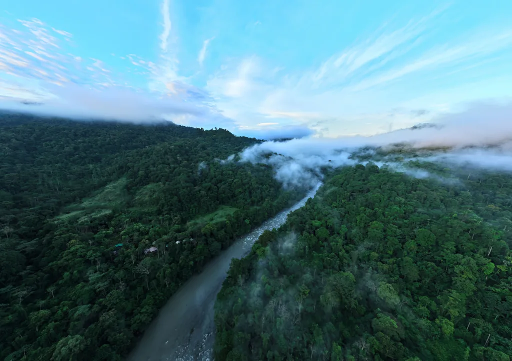 Pacuare River winding through lush rainforest under blue sky