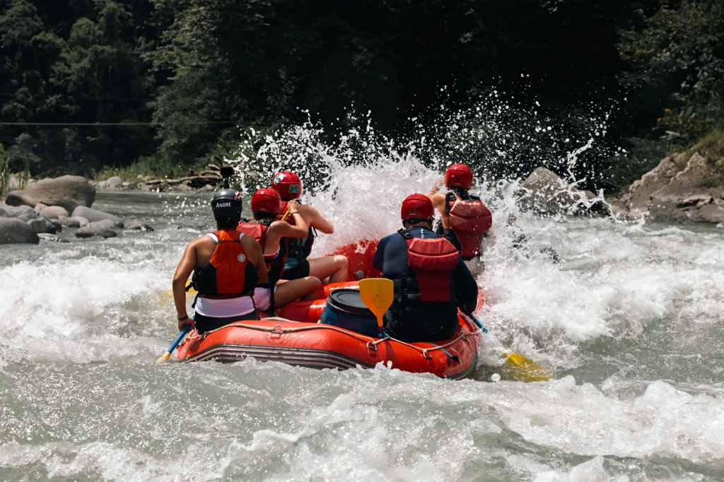 rafting adventure on Pacuare River with group in red helmets